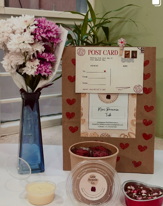 Gift hamper with flowers and a handwritten postcard